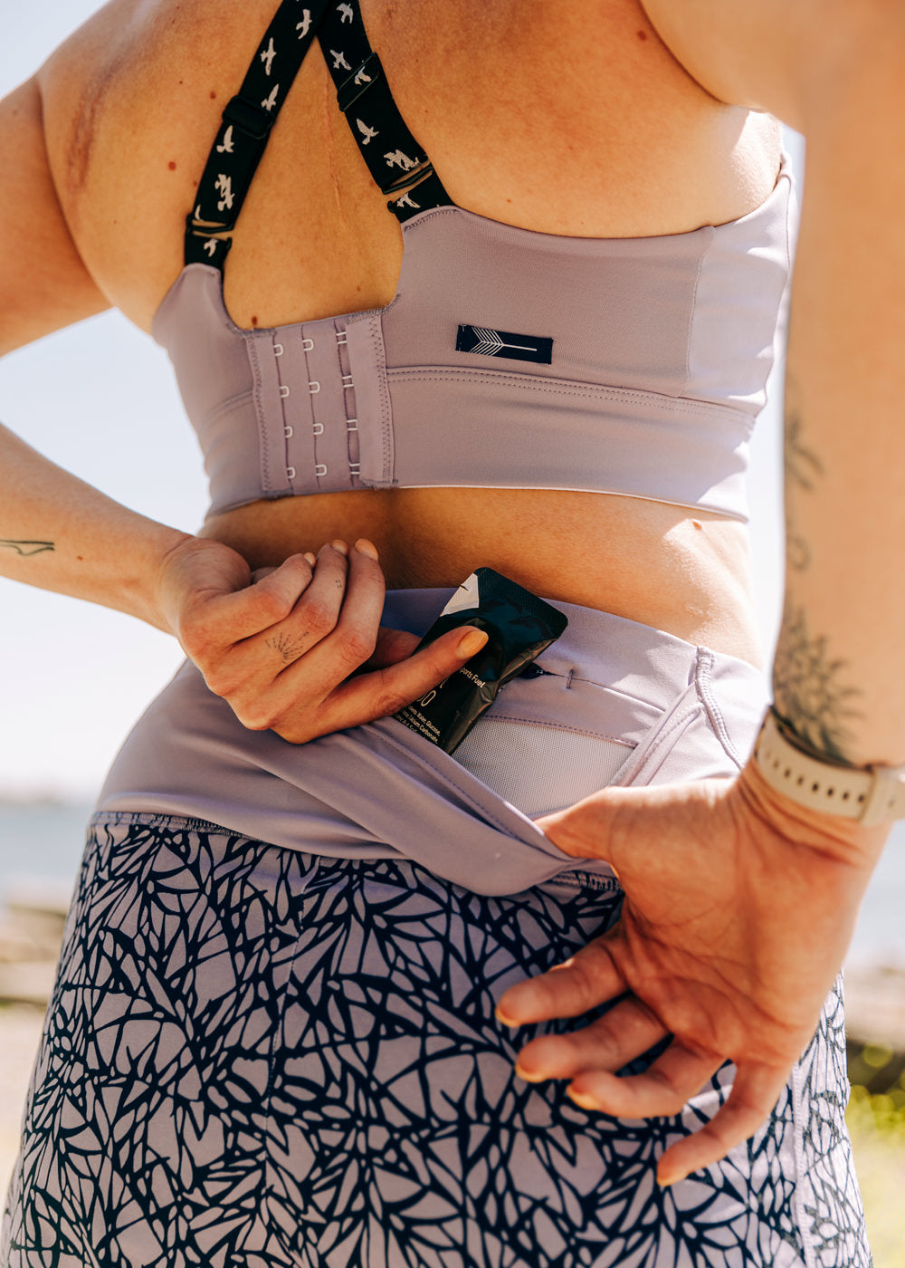 High Rise Roga 4" Running Shorts in Light Purple Lavender print, outdoor close up of back pocket detail