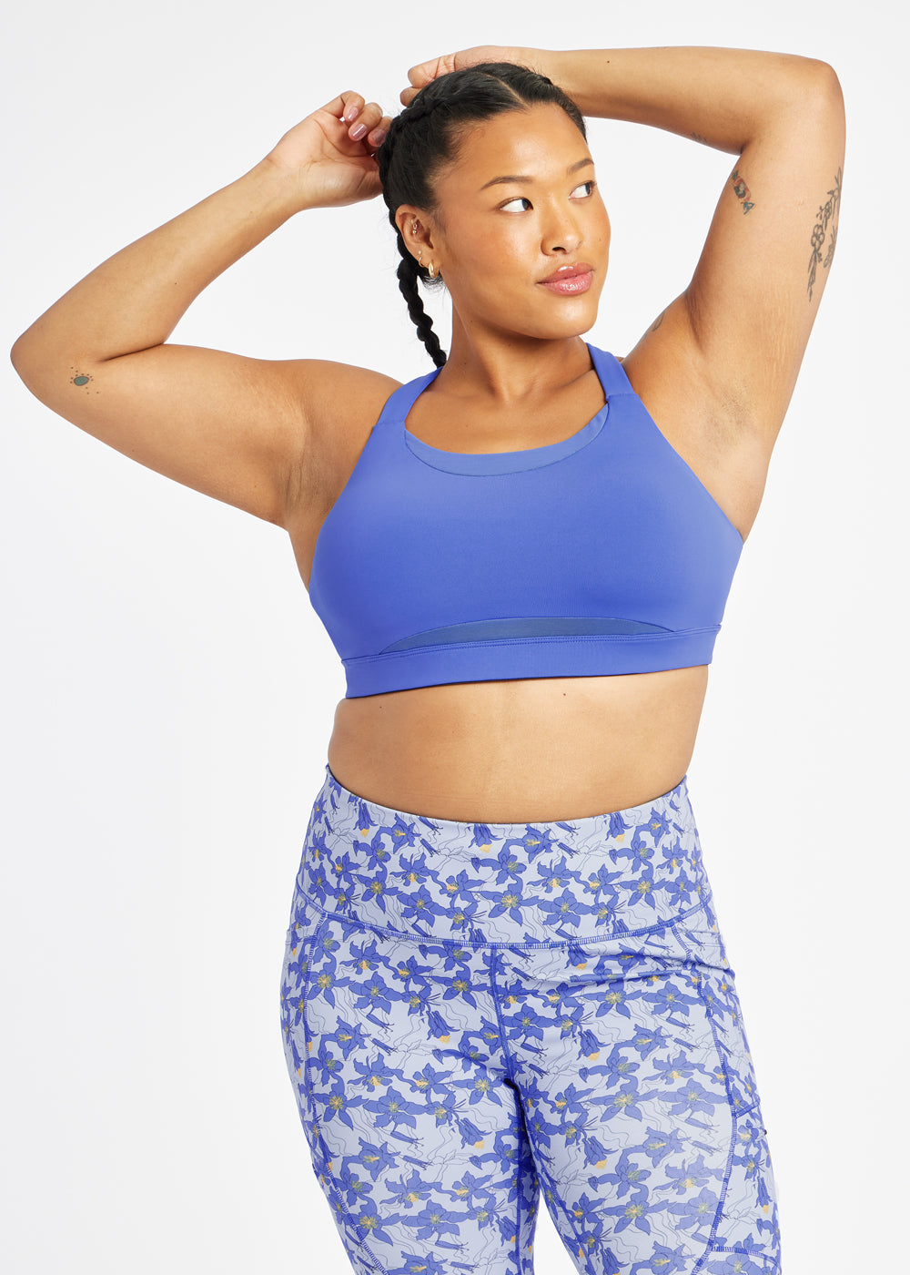 Woman wearing blue band and cup sports bra, front view