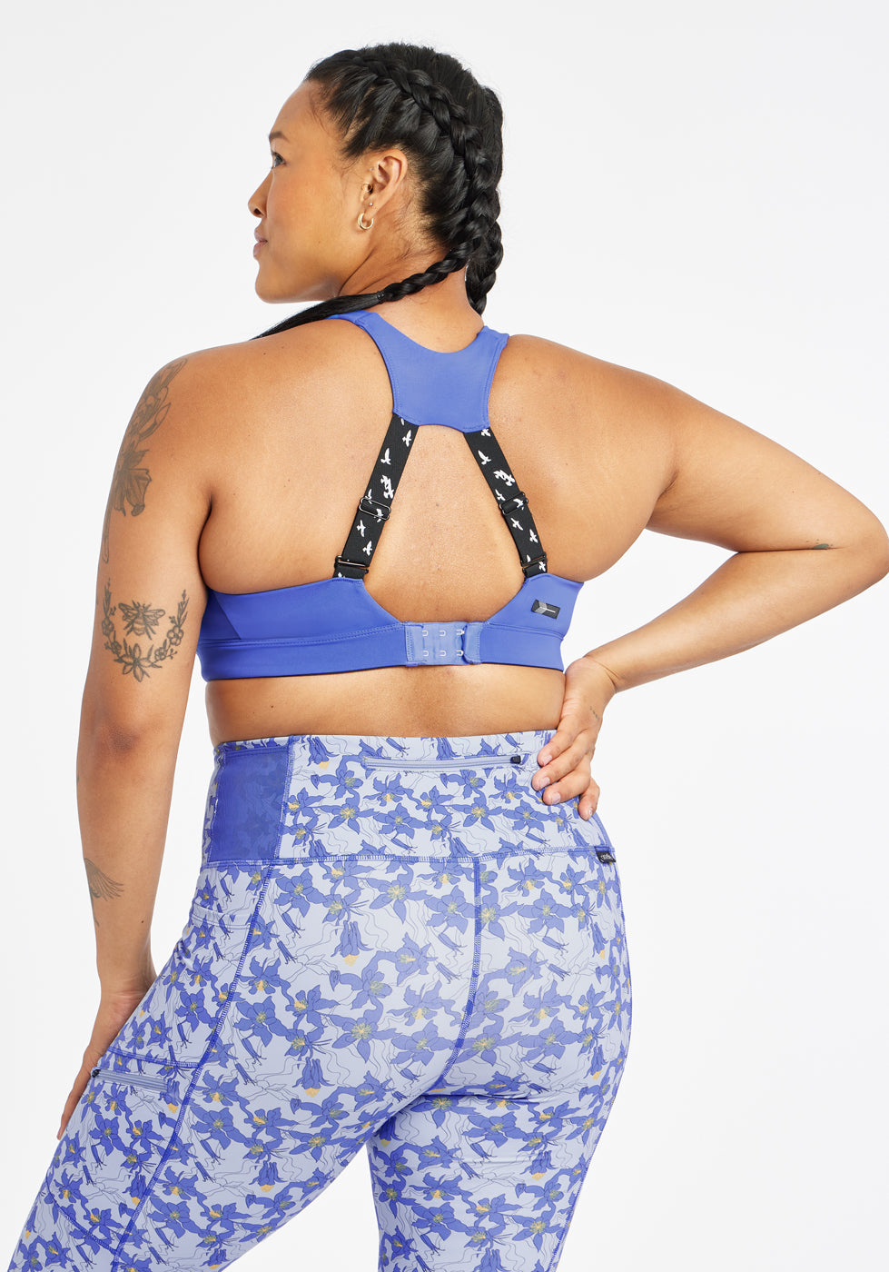 Woman wearing blue band and cup sports bra, back view