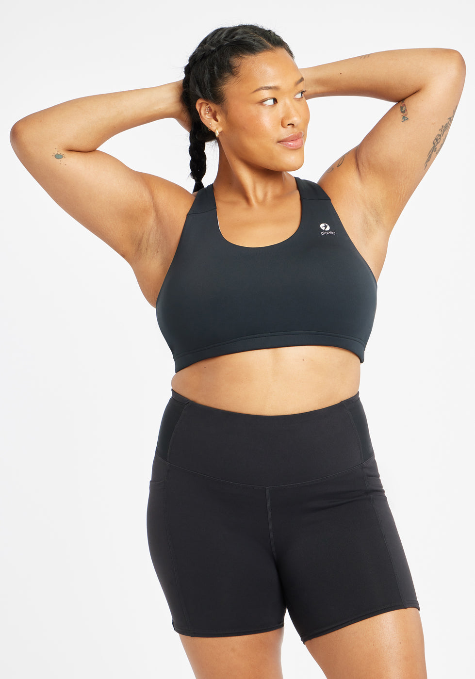 Woman wearing black and white paneled sports bra, front view