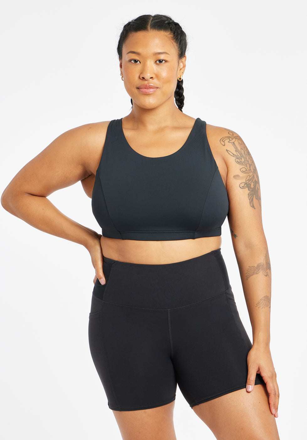 Woman wearing black sports bra in size 12, front view