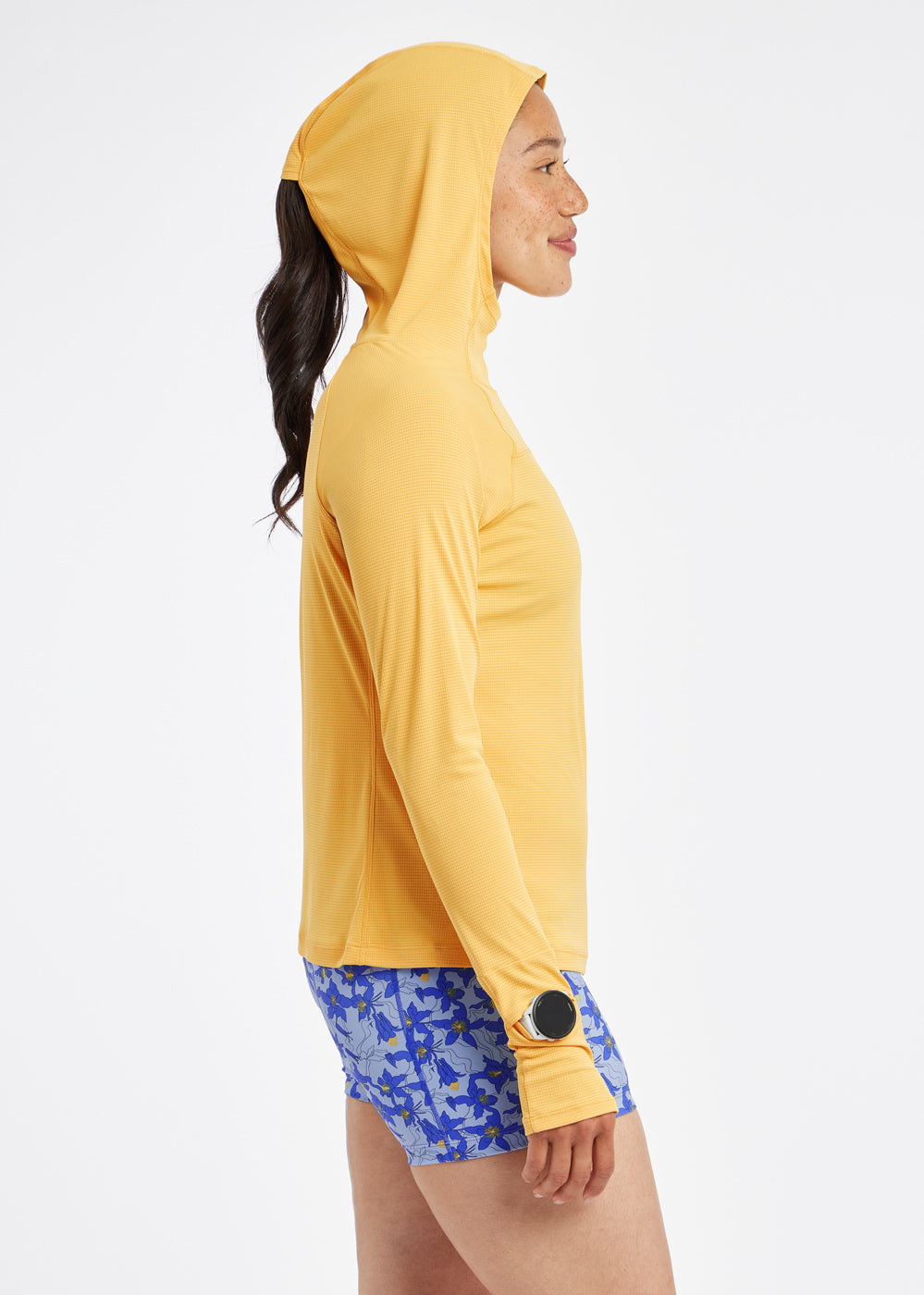 Flyout Chill UPF Lightweight Running Hoodie in Dawn Patrol light orange, side view with hood up