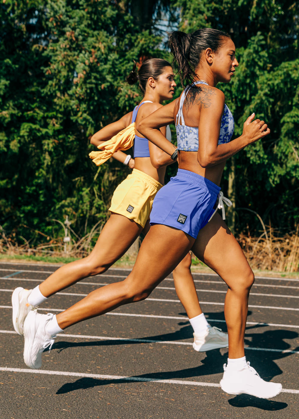 Flyout Chill Shorts in Blue Rapids, women running on a track