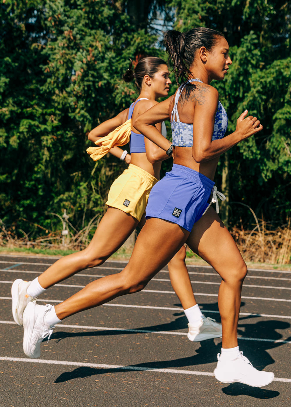 Flyout Chill Shorts in Blue Rapids, women running on a track