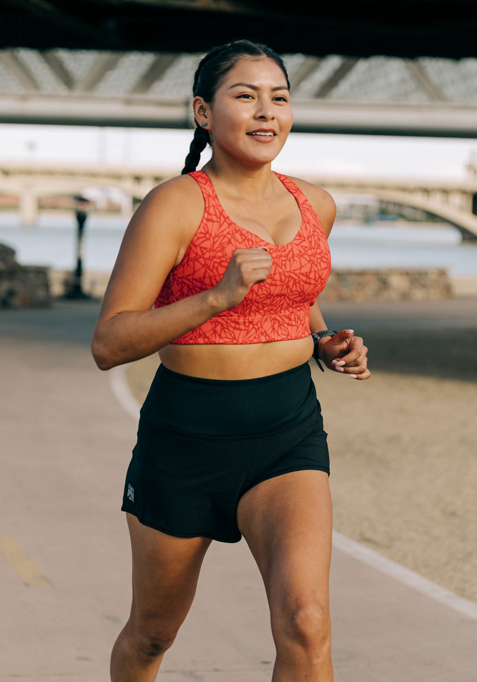 Woman running outside in High Rise Roga 4" Running Shorts and Oiselle sports bra