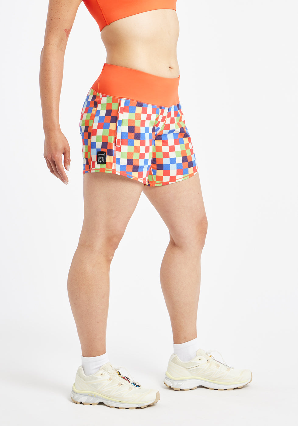 Roga 6" Running Shorts in colorful checkered print with orange waistband, side view