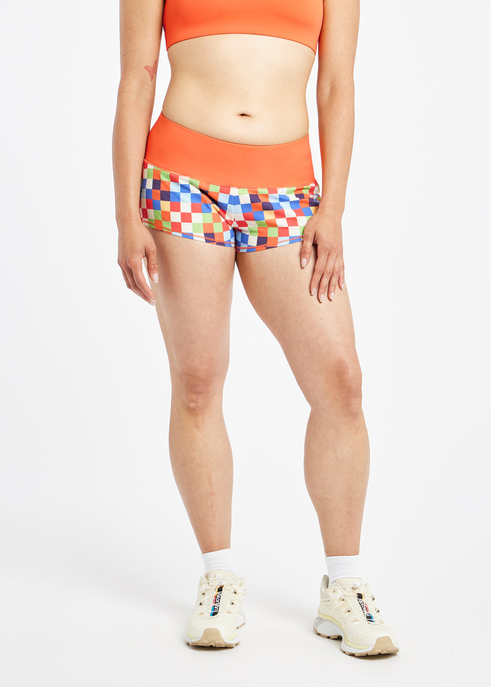 Roga 1.75" Running Shorts in colorful checkered print with orange waistband, front view
