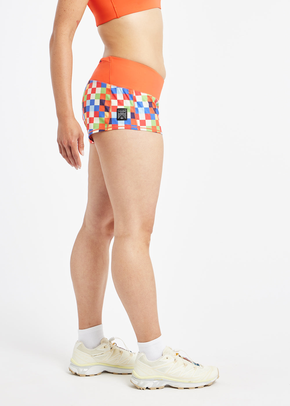 Roga 1.75" Running Shorts in colorful checkered print with orange waistband, side view