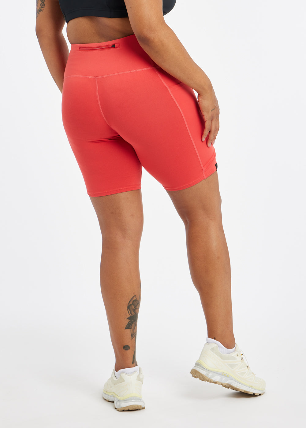 Woman wearing red orange compression shorts in size 12, back view