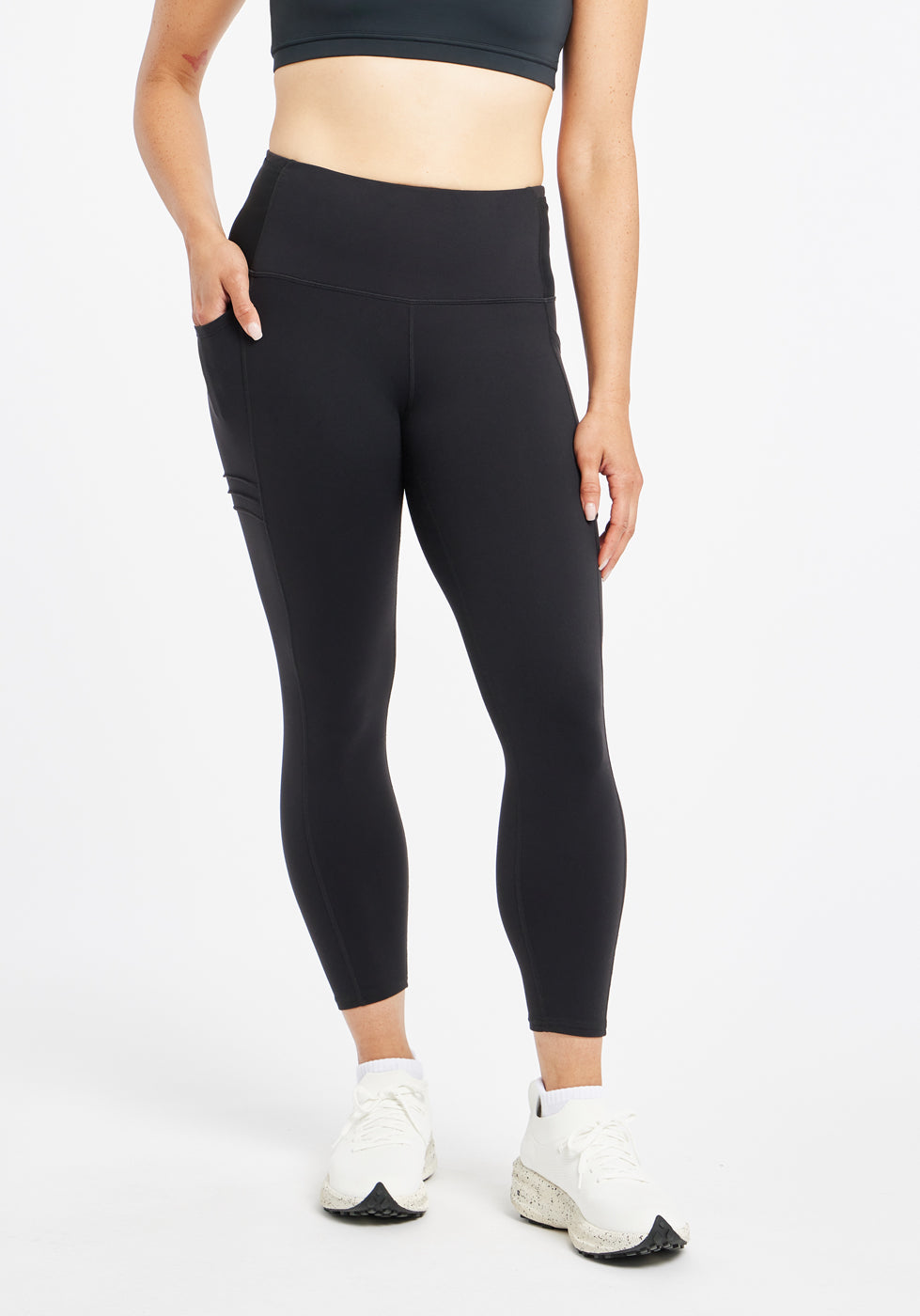 Woman wearing black compression tights in size 4, alternate front view