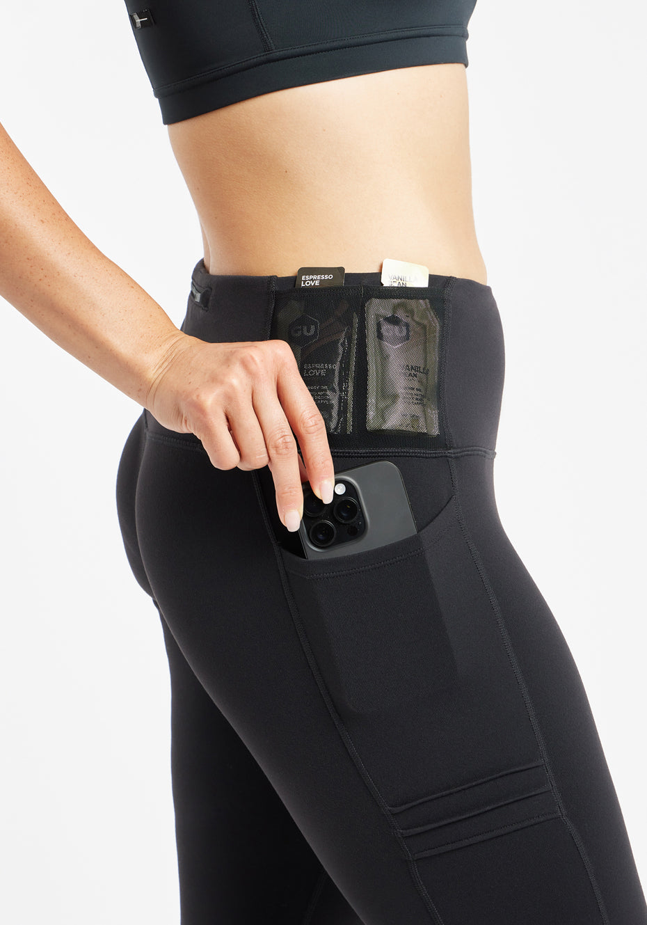 Woman wearing black compression tights, close up of side pockets