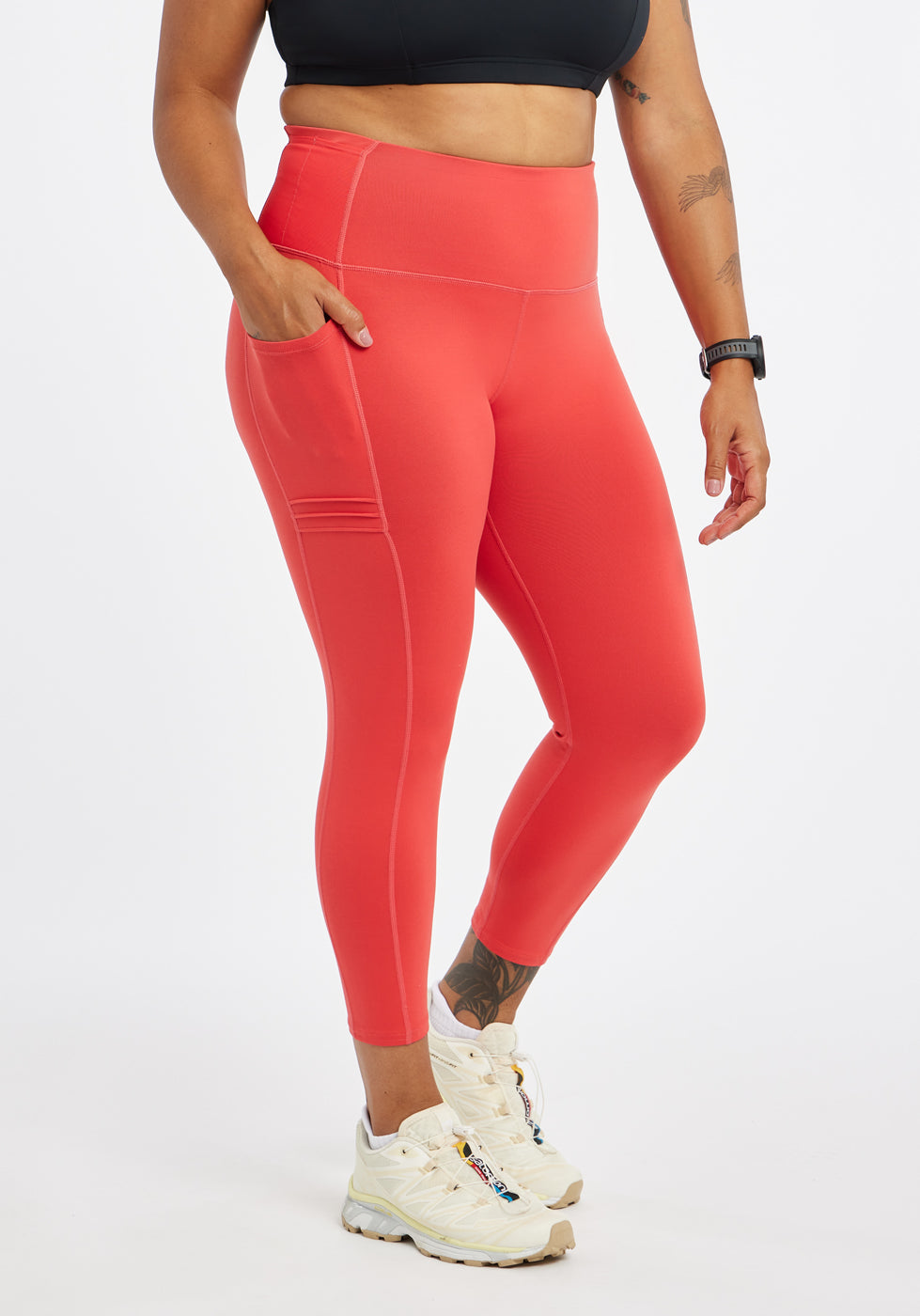 Woman wearing red orange compression tights in size 12, front view