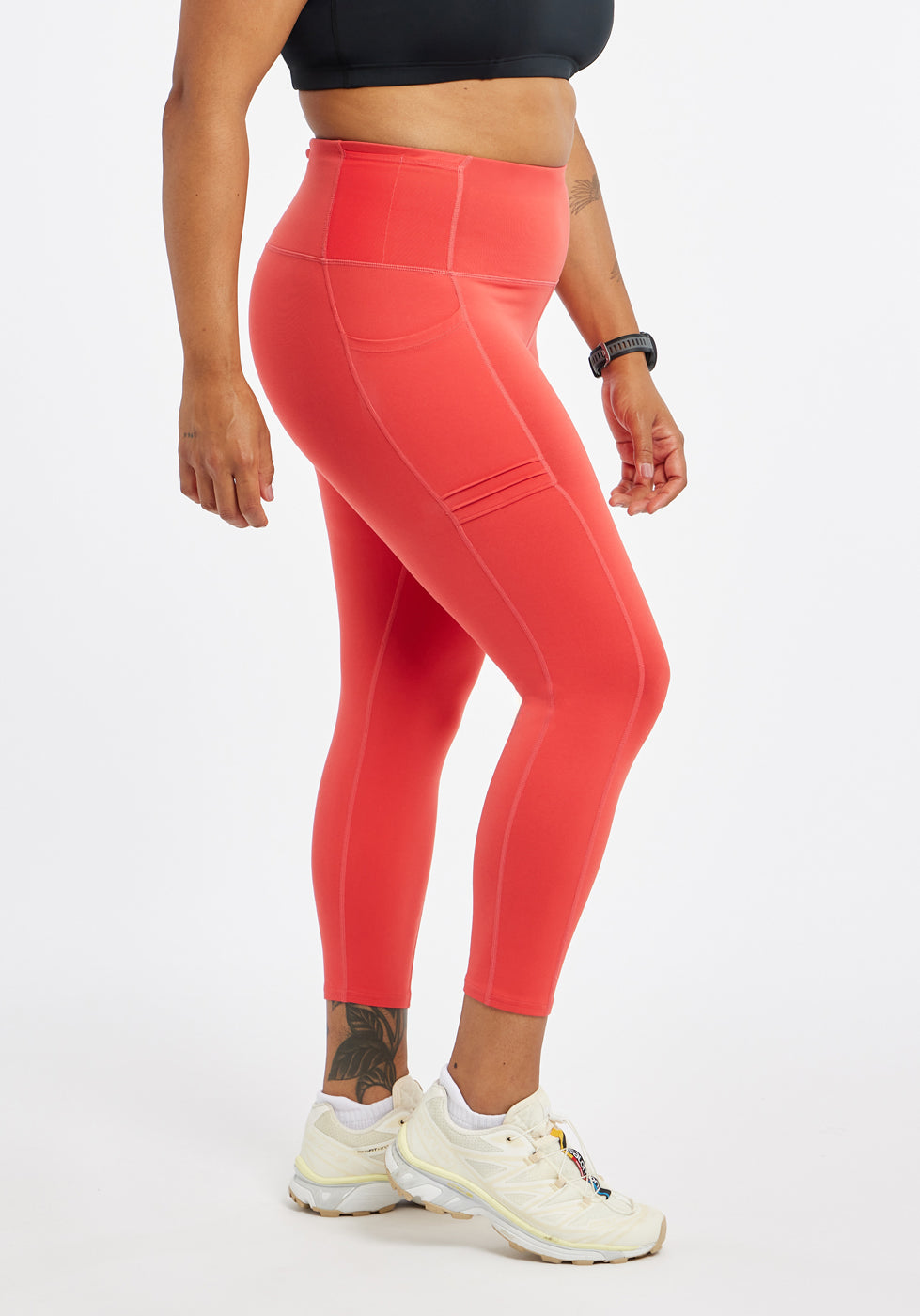 Woman wearing red orange compression tights in size 12, side view