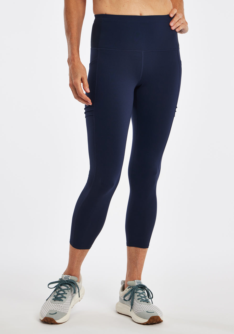 Woman wearing dark blue compression tights in size 4, front view