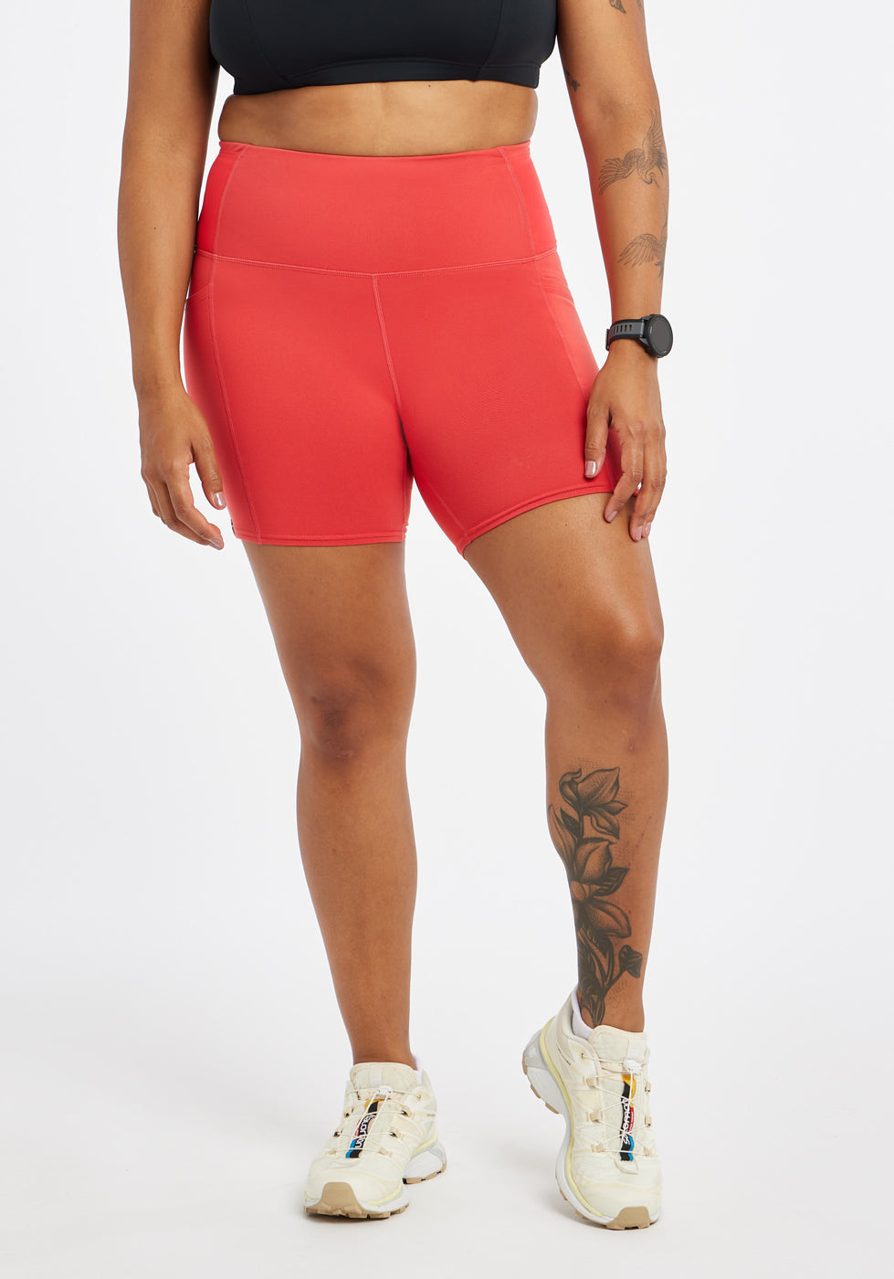 Woman wearing red orange compression shorts in size 12, front view