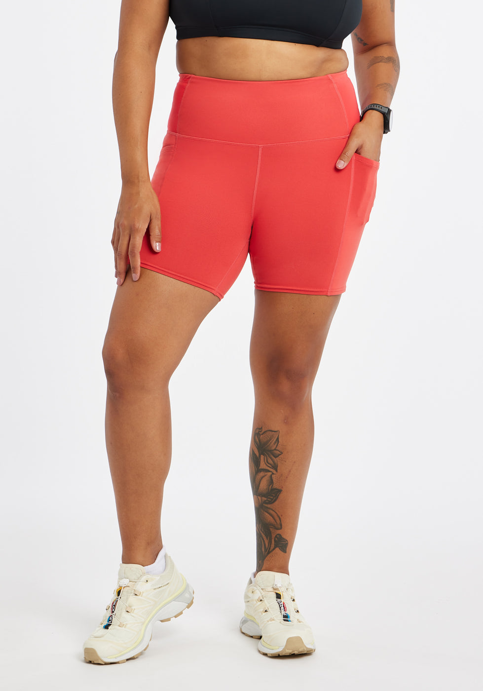 Woman wearing red orange compression shorts in size 12, alternate front view