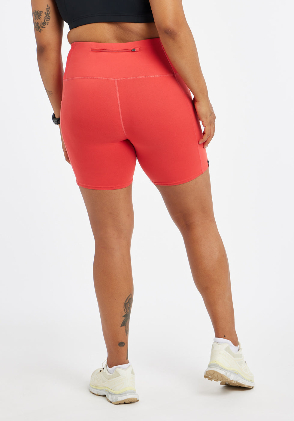 Woman wearing red orange compression shorts in size 12, back view