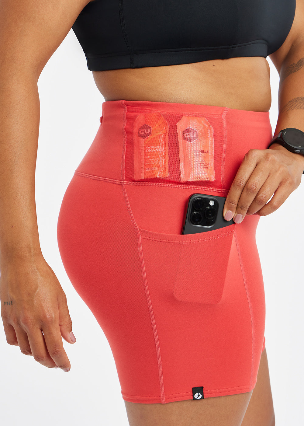 Woman wearing red orange compression shorts, close up of side pockets