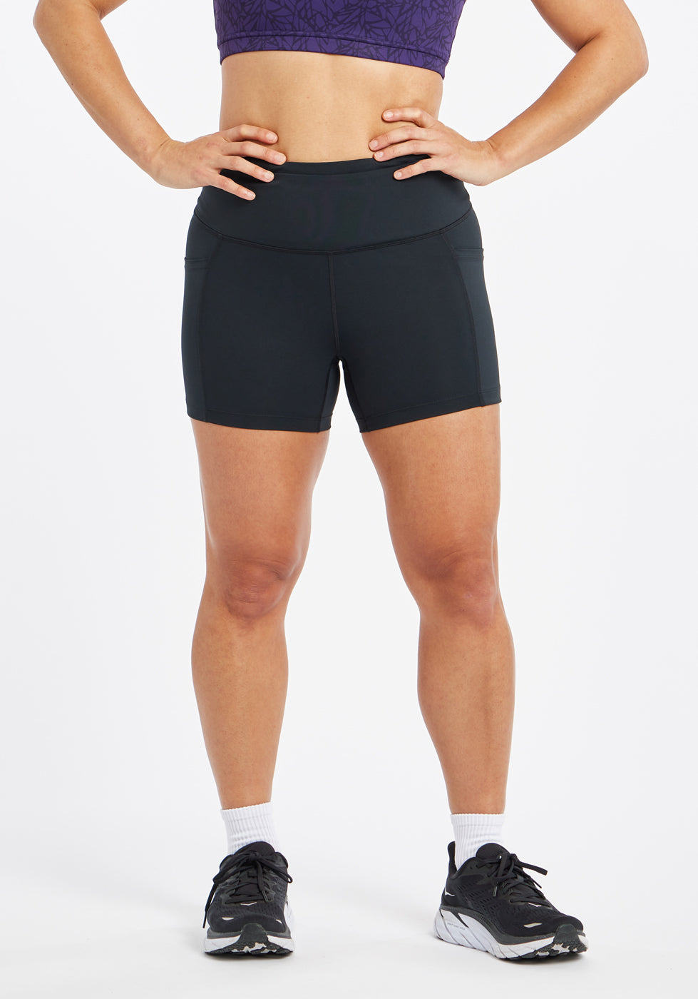 Woman wearing black compression shorts in size 6, front view