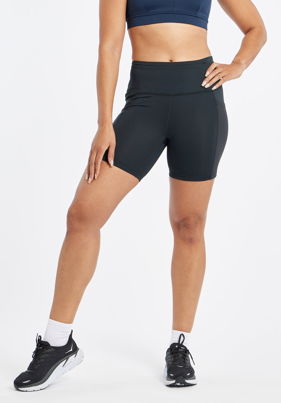 Woman wearing black compression shorts in size 6, front view