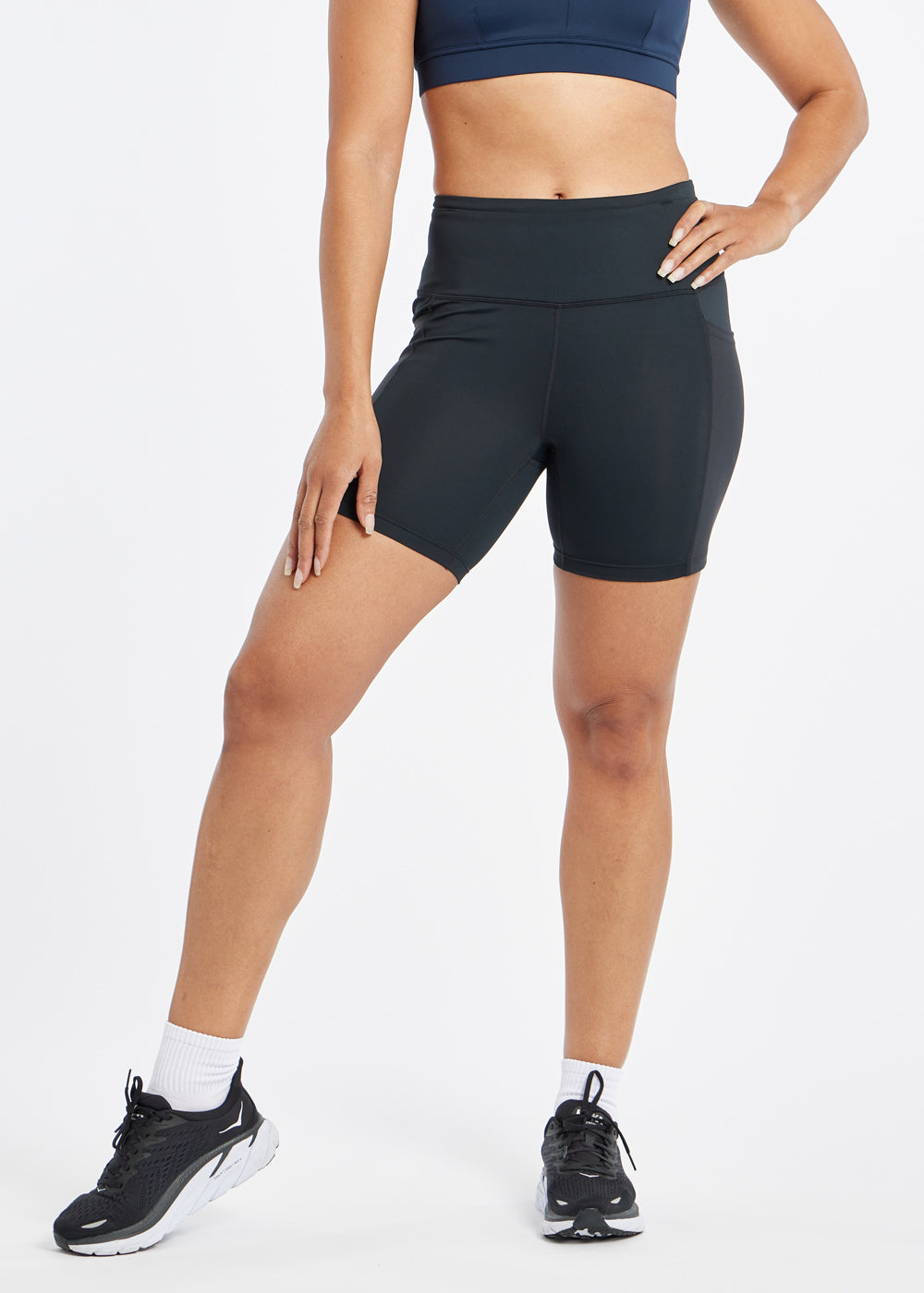 Woman wearing black compression shorts in size 6, front view