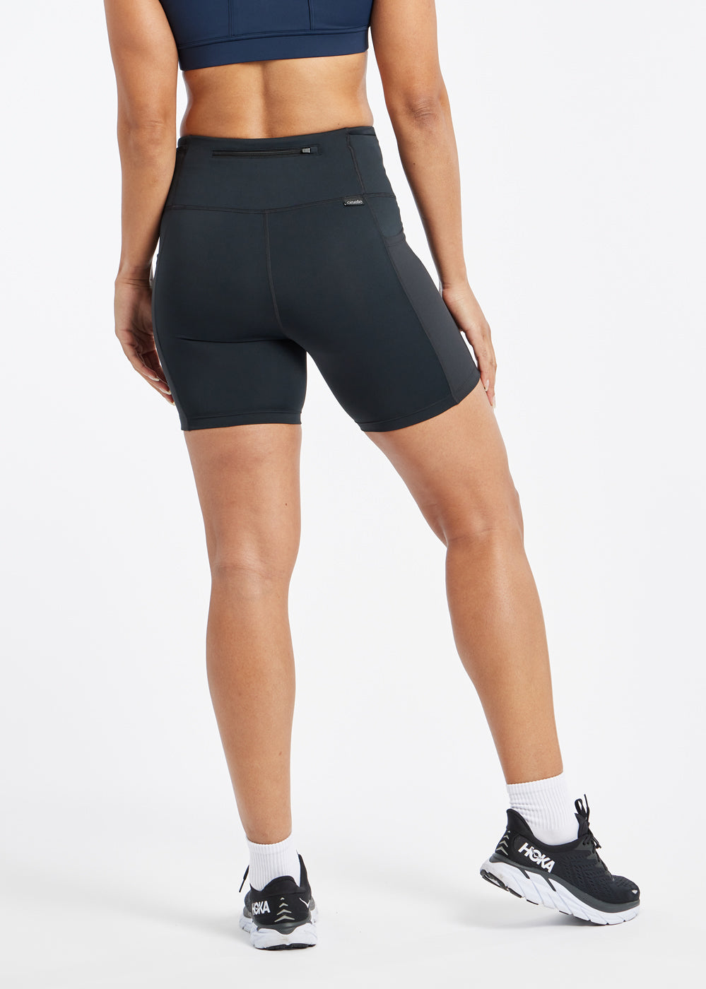 Woman wearing black compression shorts in size 6, back view