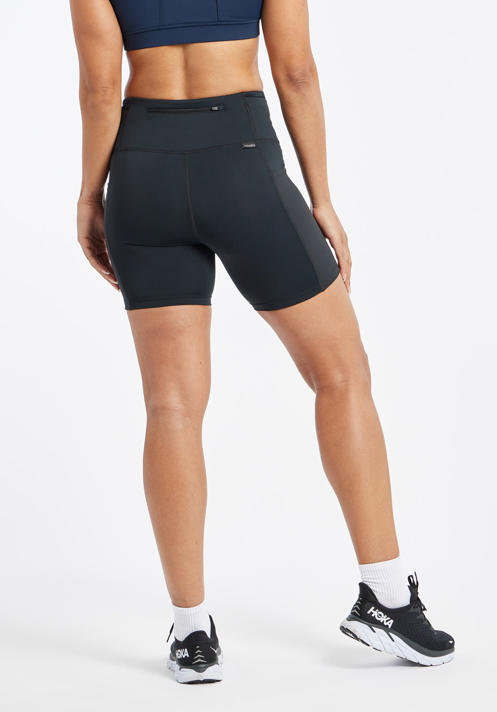 Woman wearing black compression shorts in size 6, back view