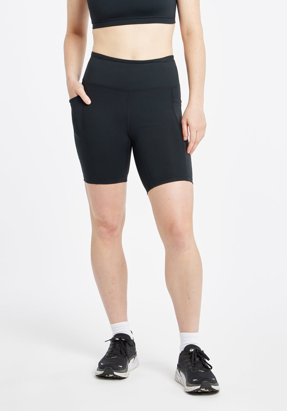 Woman wearing black compression shorts in size 6, front view