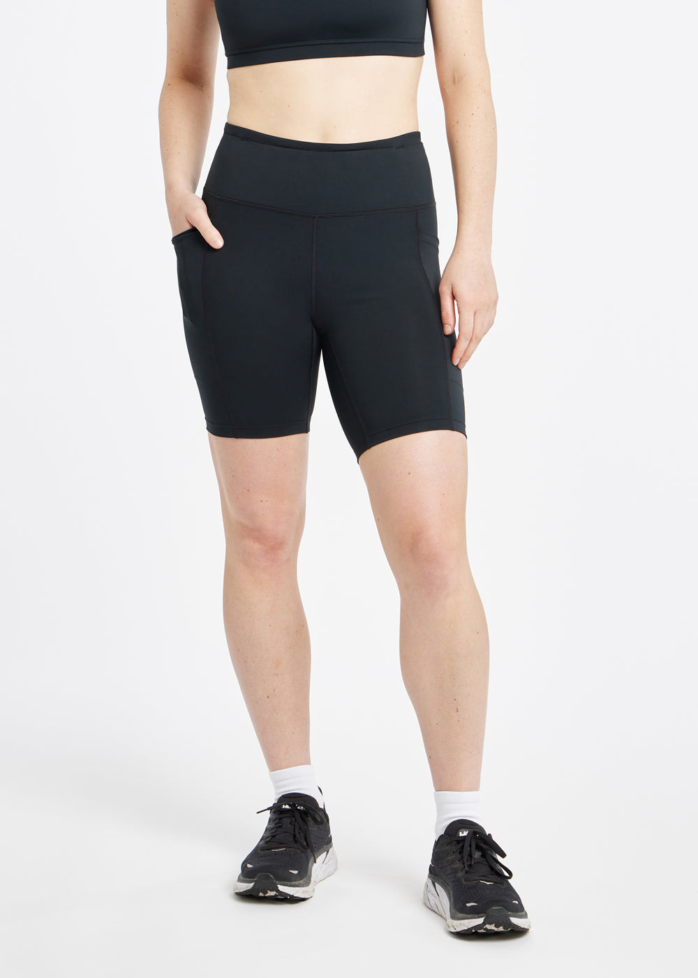 Woman wearing black compression shorts in size 6, front view