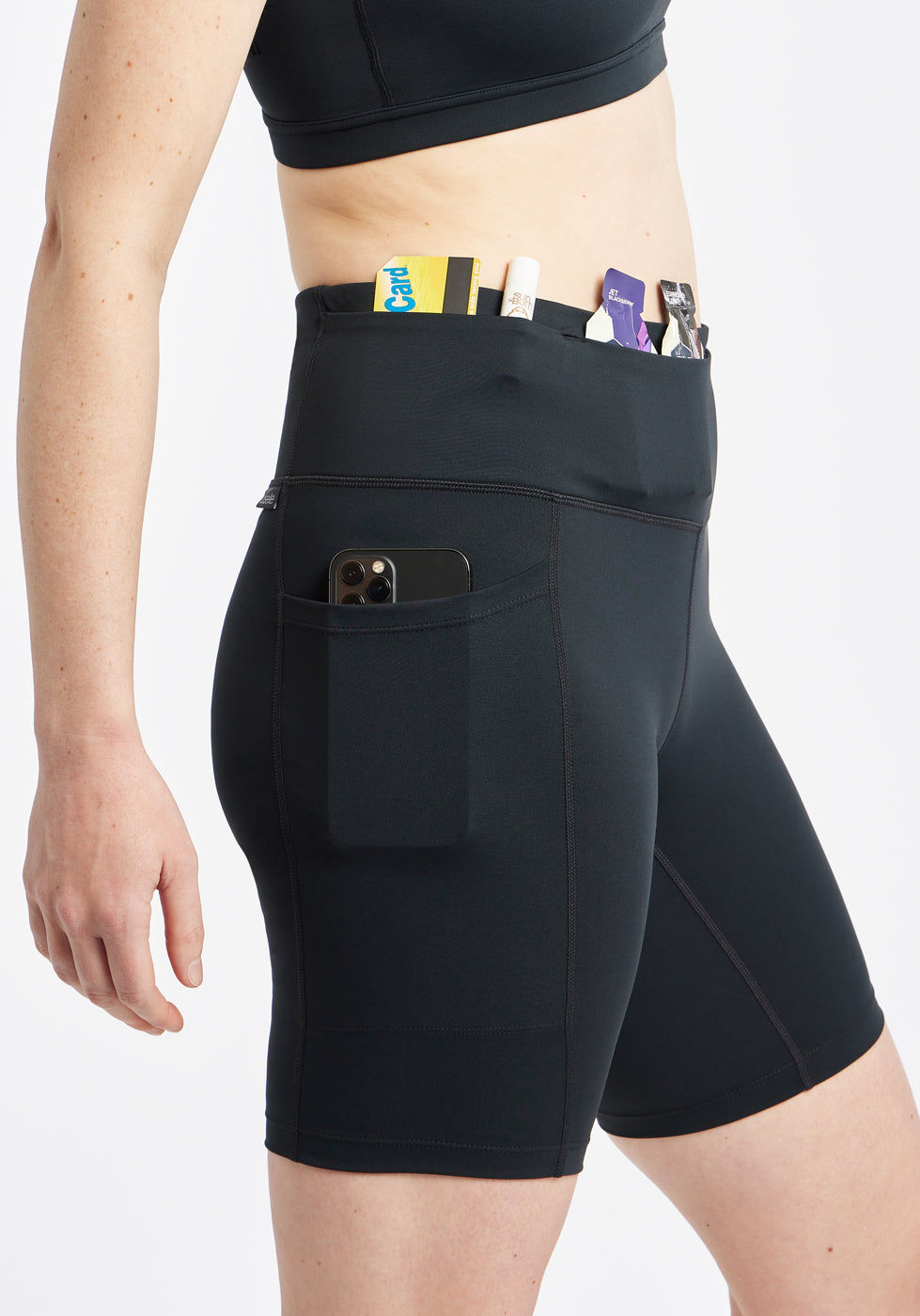 Woman wearing black compression shorts, close up of side pockets