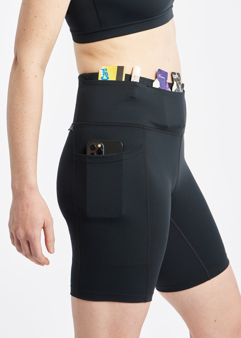 Woman wearing black compression shorts, close up of side pockets