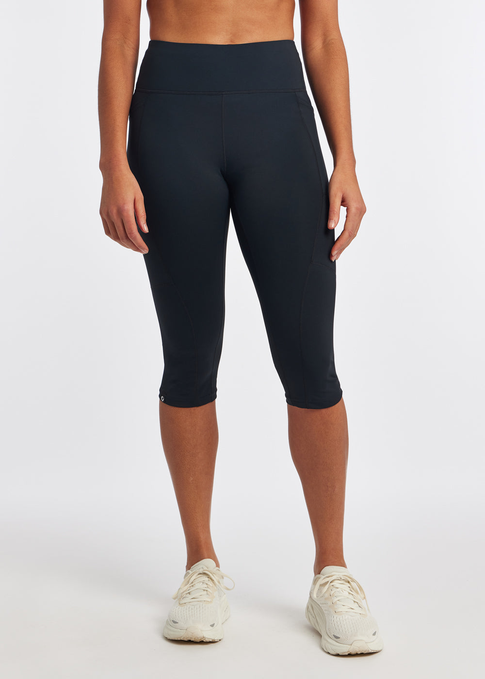 Woman wearing black running knickers in size 4, front view