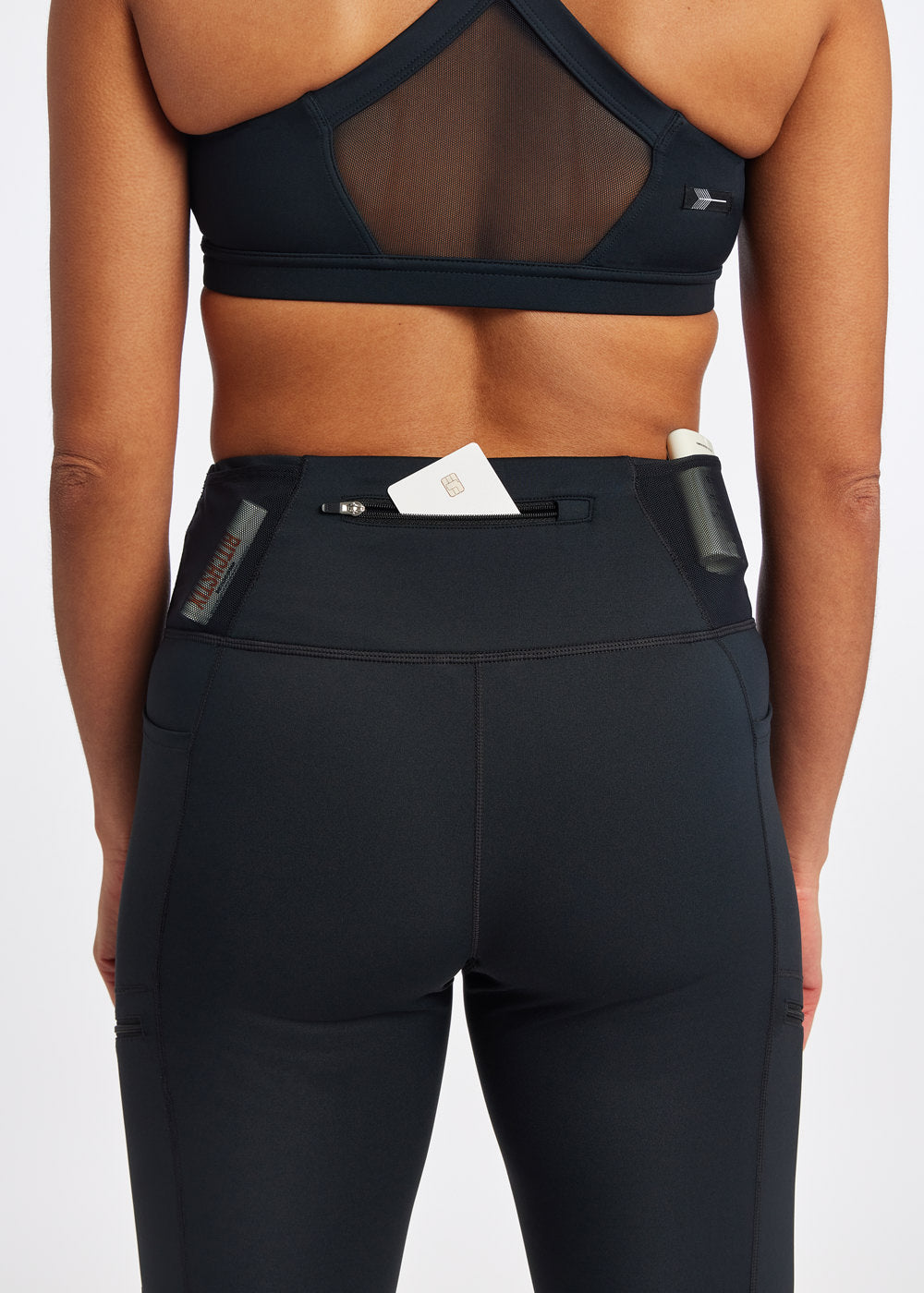 Woman wearing black knickers in size 4, close up view of back pockets