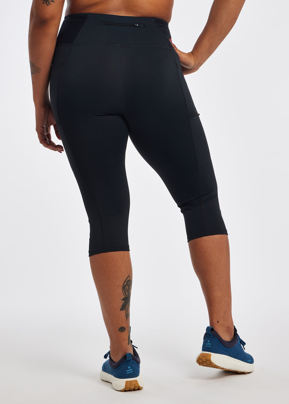 Woman wearing black running knickers in size 12, back view