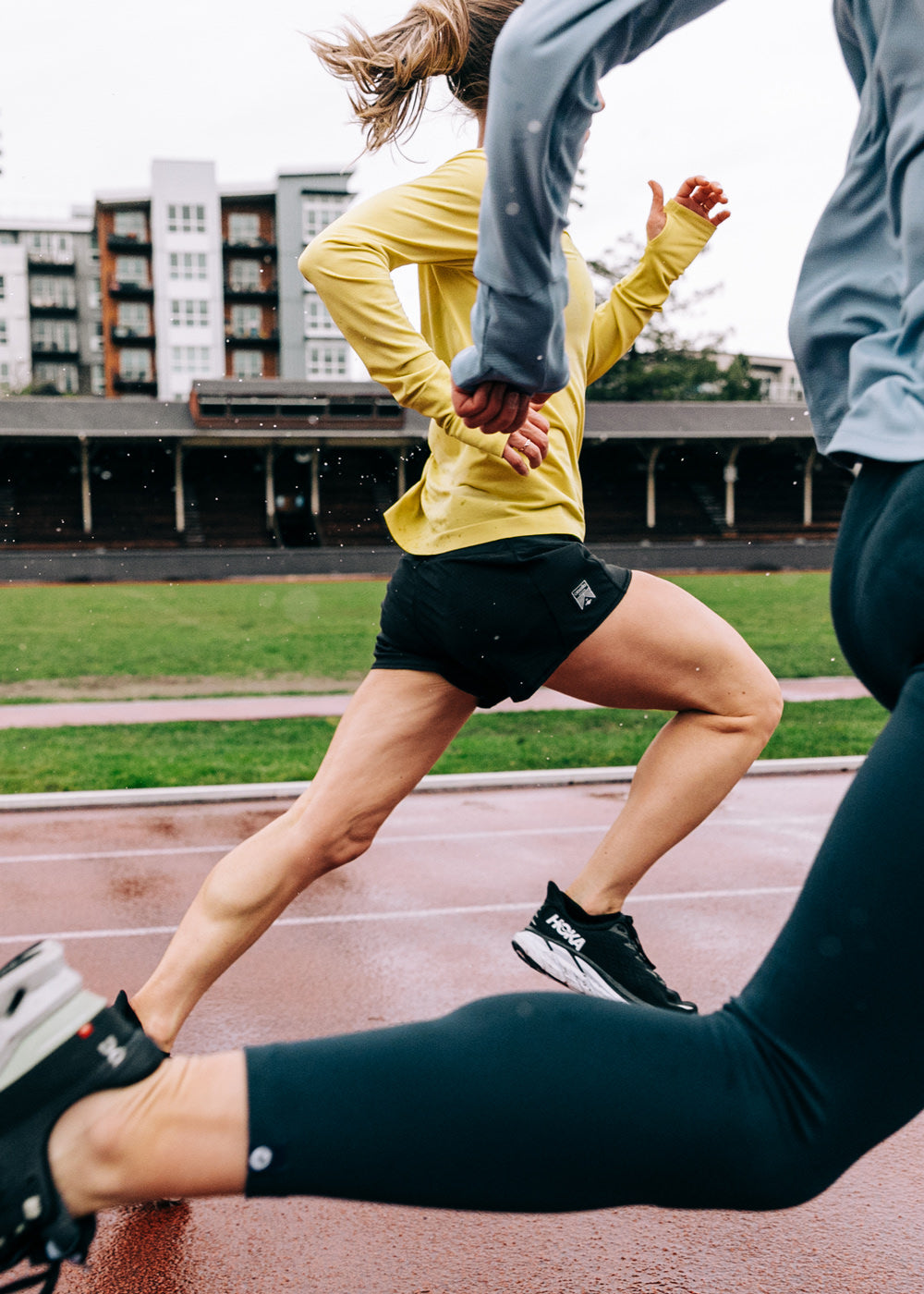 Women running on a track in Roga 4" Running Shorts in Black