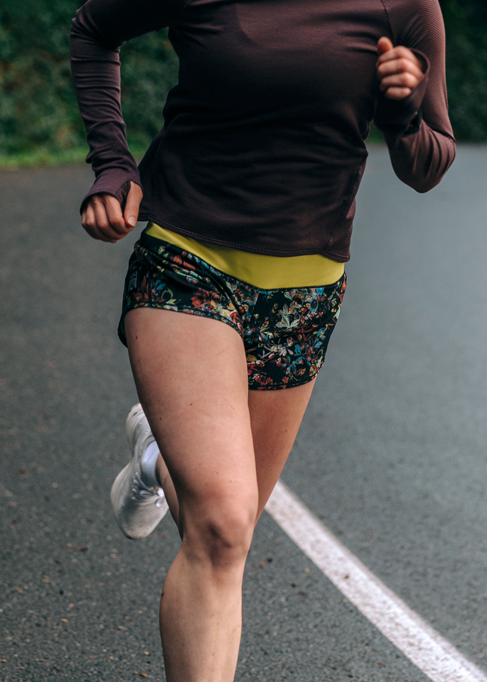 Woman running in Roga 4" Running Shorts in Dark Floral print, front view
