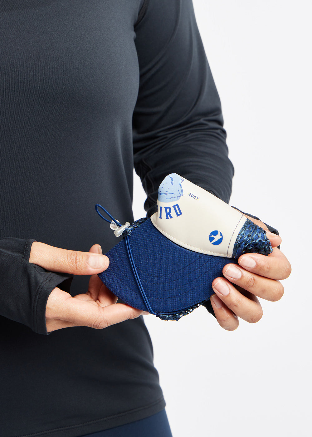 Runner Trucker Hat in Ivory with Give Em The Bird logo, foldable detail view