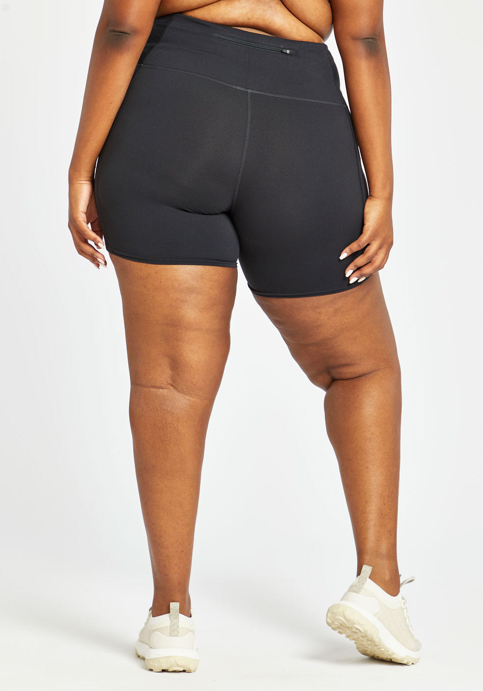 Woman wearing black compression shorts in size 16/18, back view