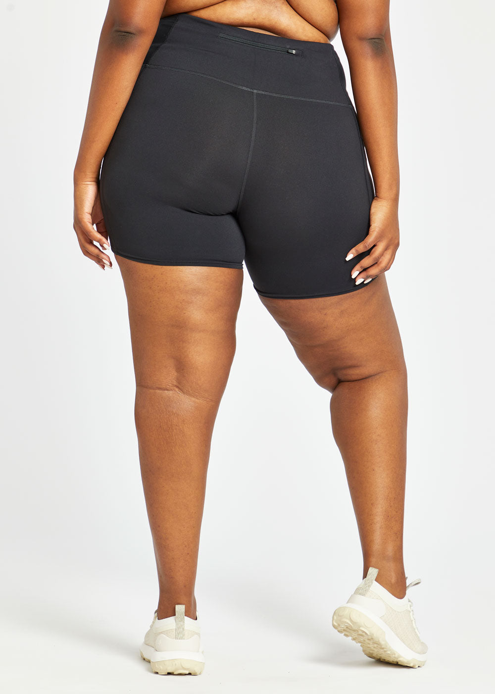 Woman wearing black compression shorts in size 16/18, back view