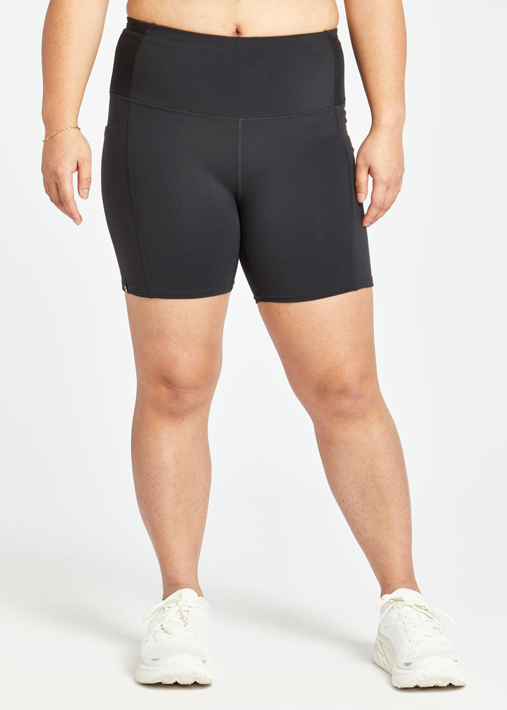 Woman wearing black compression shorts in size 8, front view