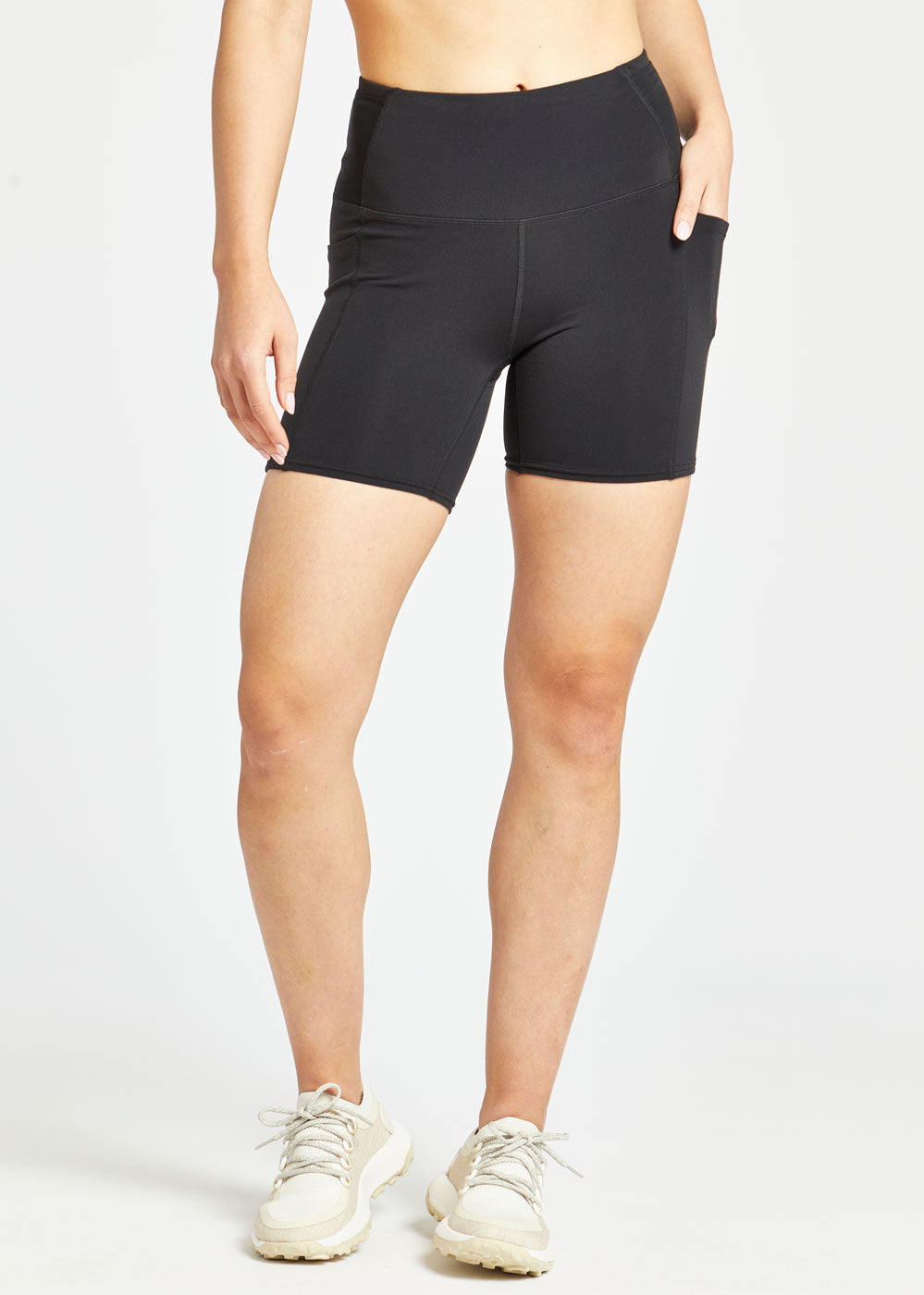 Woman wearing black compression shorts in size 4, front view