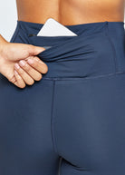 Essential Bird 3/4 length Running Tights in Ink Blue, back pocket detail view