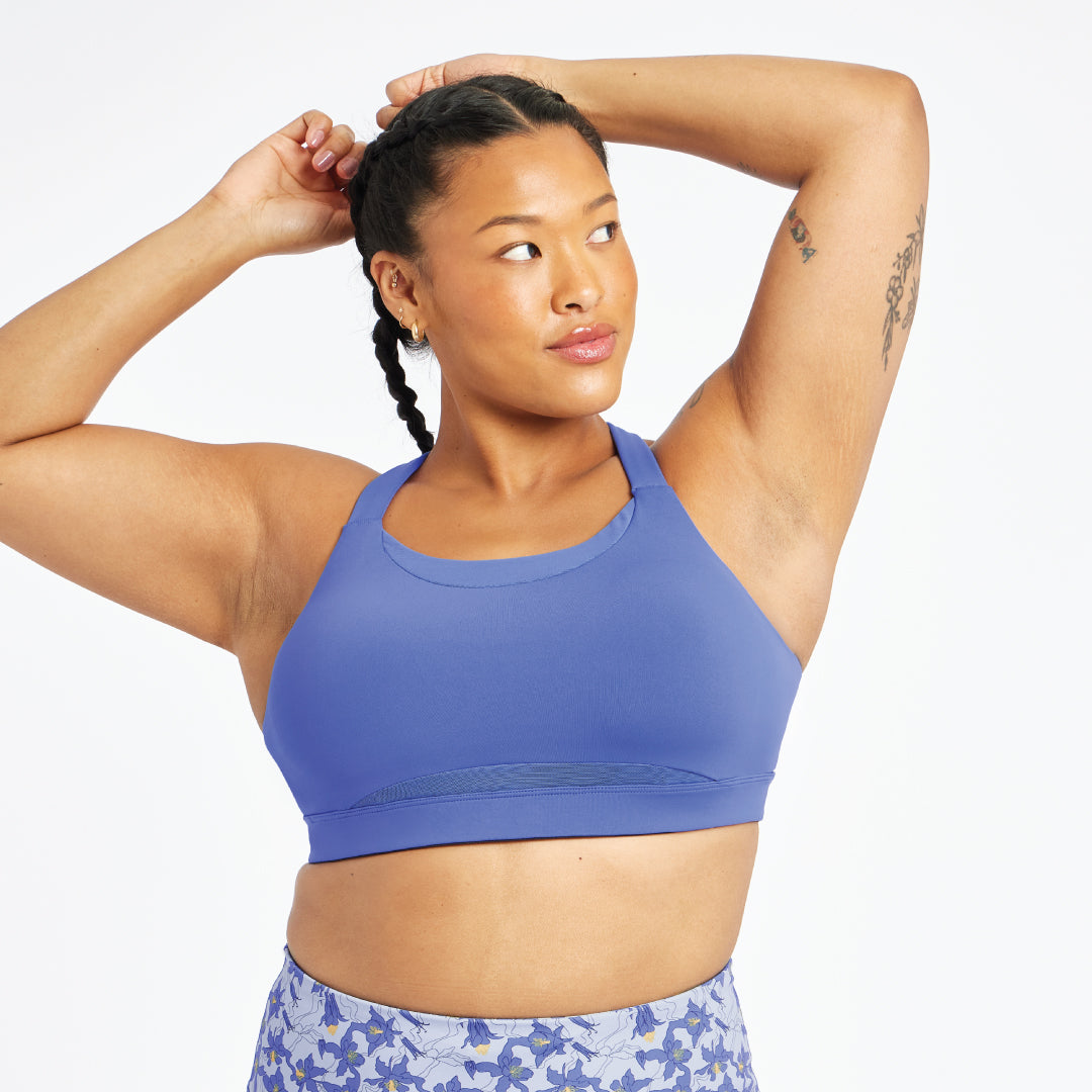 Woman wearing blue Oiselle band and cup bra, front view
