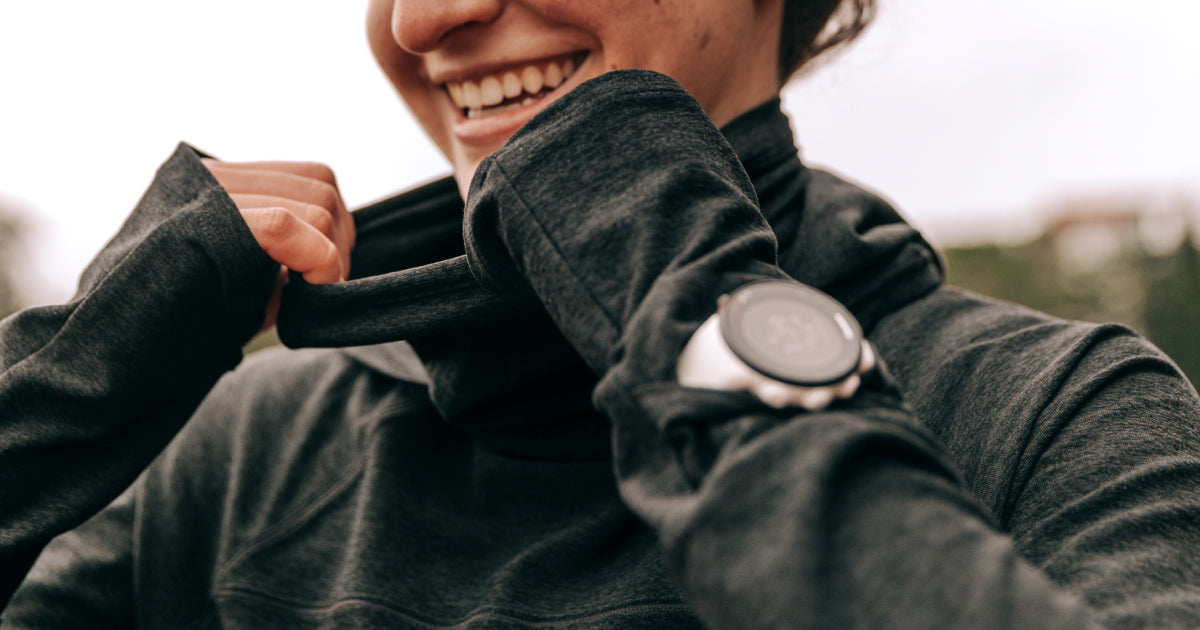 Woman wearing Oiselle hooded long sleeve with a cowl neck