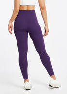 Essential Bird 7/8 length Running Tights in Twilight purple, back view