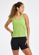 Woman wearing a green running tank top and black compression shorts, front view