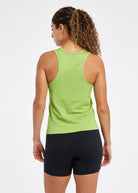 Woman wearing a green running tank top and black compression shorts, back view