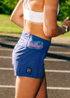 Woman wearing Oiselle running shorts on a track