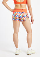Roga 1.75" Running Shorts in colorful checkered print with orange waistband, back view