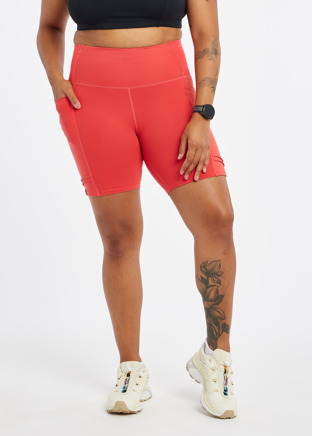 Woman wearing red orange compression shorts in size 12, front view
